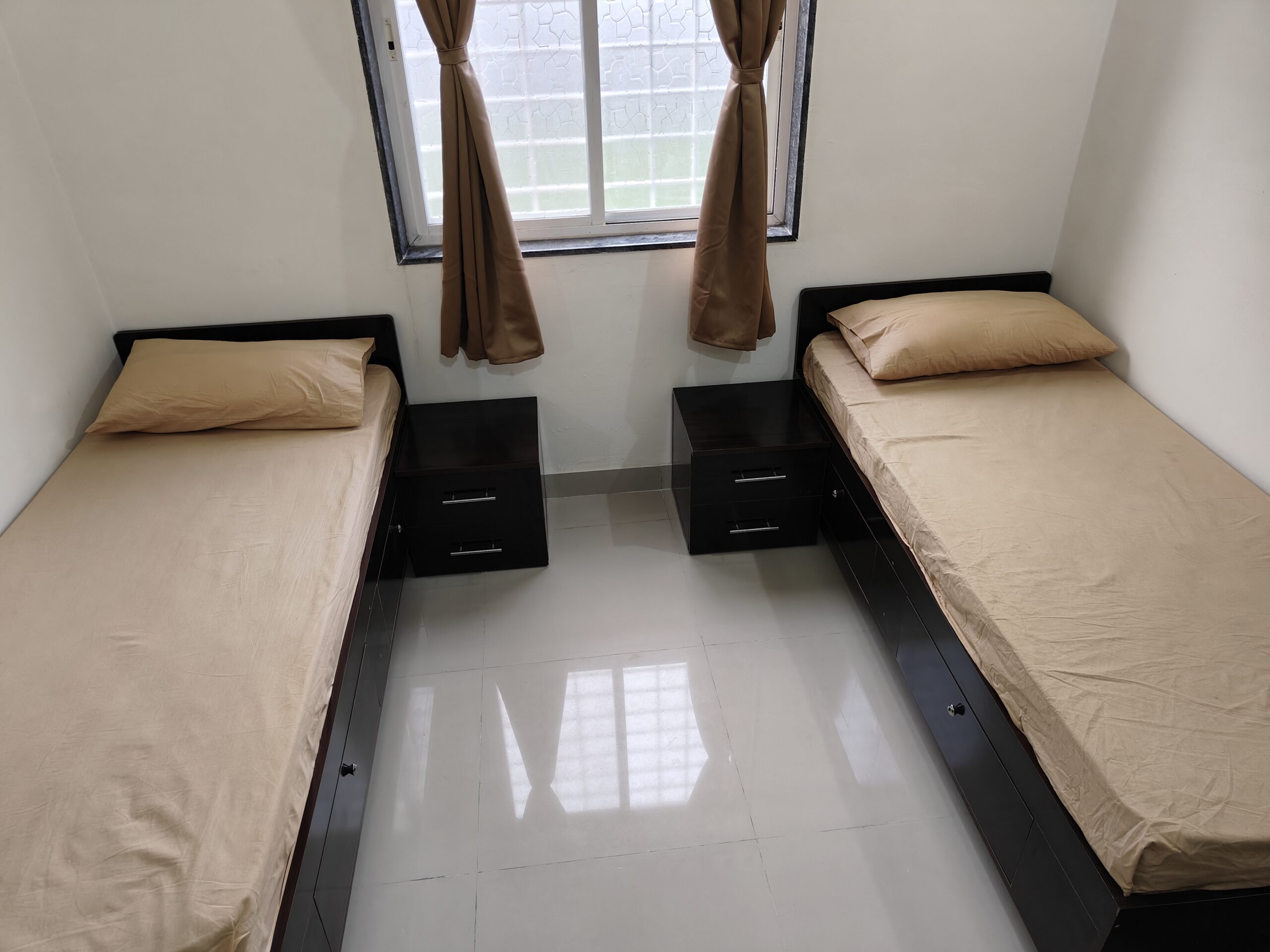 Bedroom with 2 beds, personal cupboards and natural lighting in Hinjewadi flat
